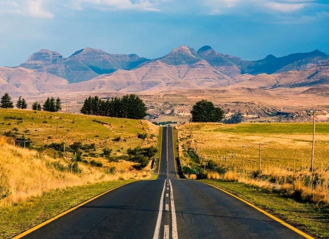 An open road stretching towards African mountains
